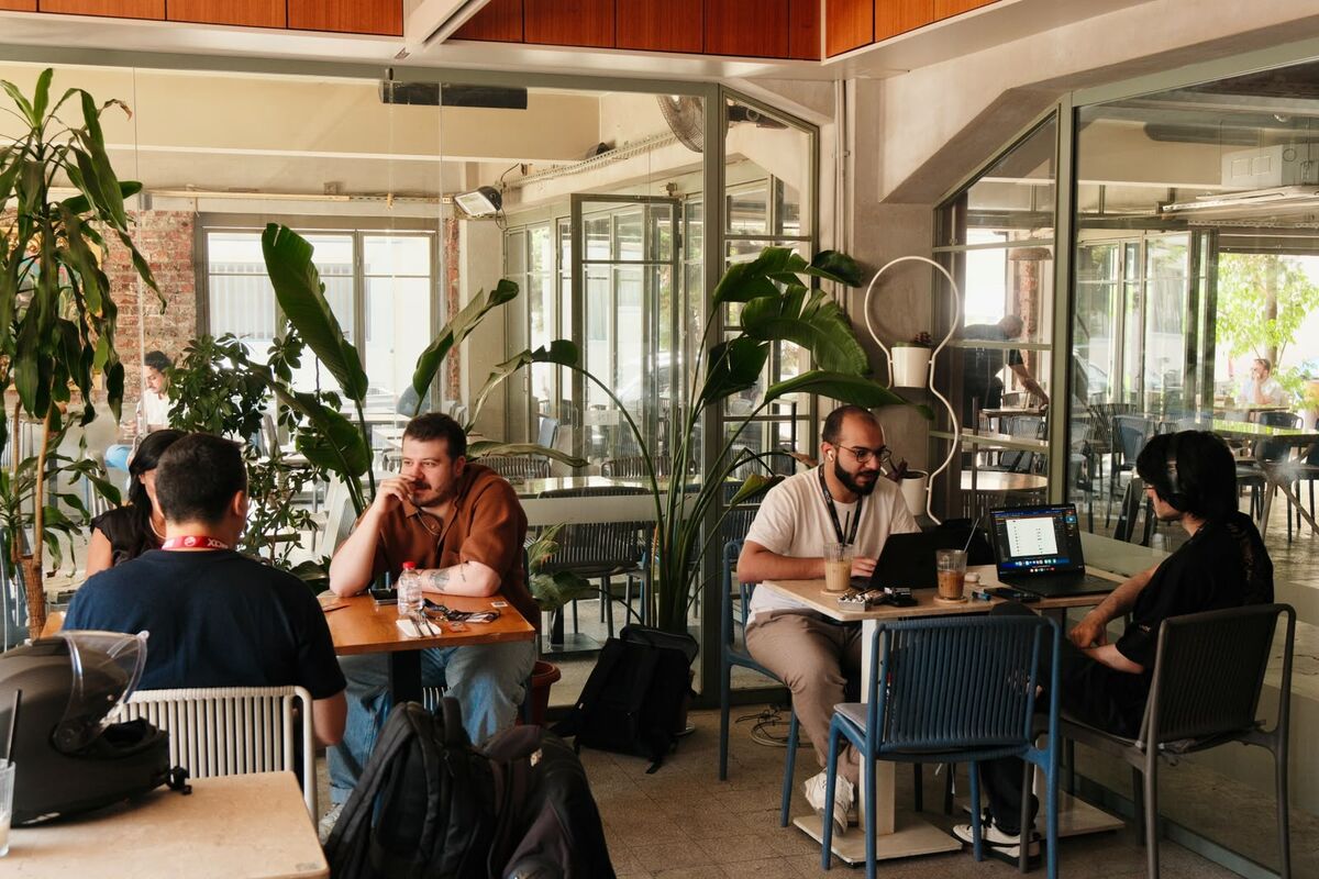 Builders working at tables by the windows